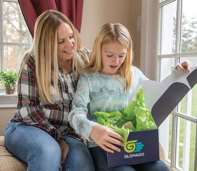 Mother and daughter opening GLOMADO box